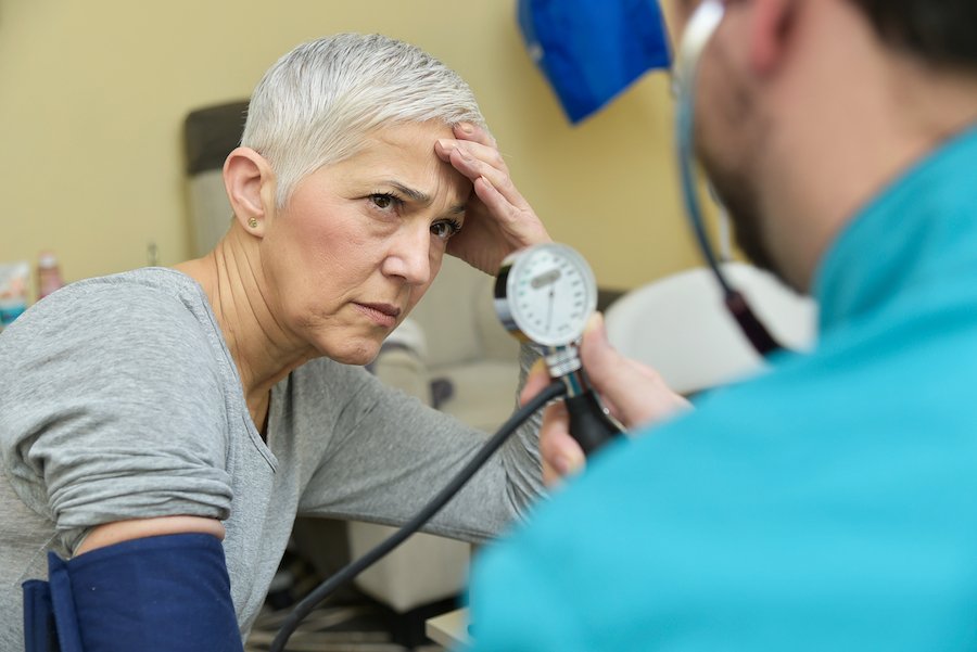 Woman taking blood pressure