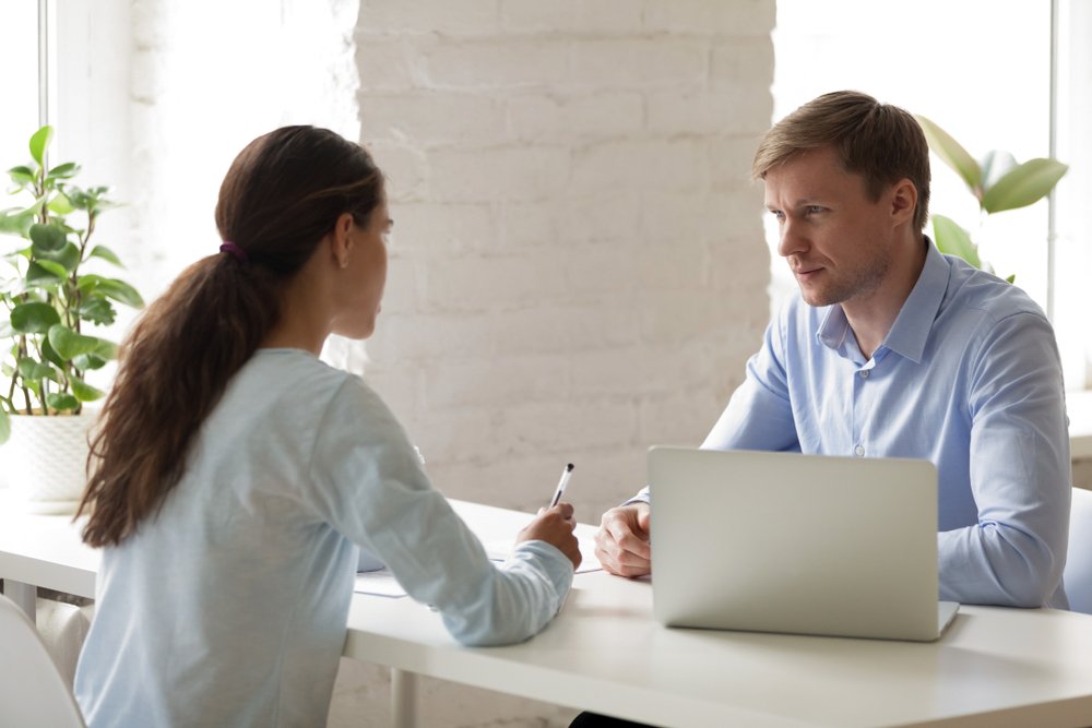A boss and an employee having a meeting.