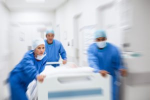 Doctors and nurses rushing a patient to the emergency room.