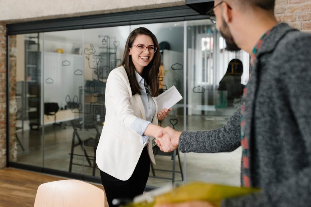 An interviewee shaking hands with the interviewer.