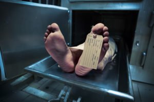 A deceased body going into a morgue.