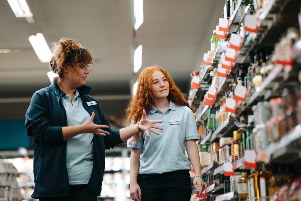 A store manager training her part-time retail employee.