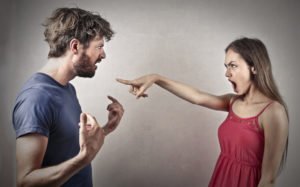 A woman pointing her finger at a man accusing him (possibly of sexual assault).