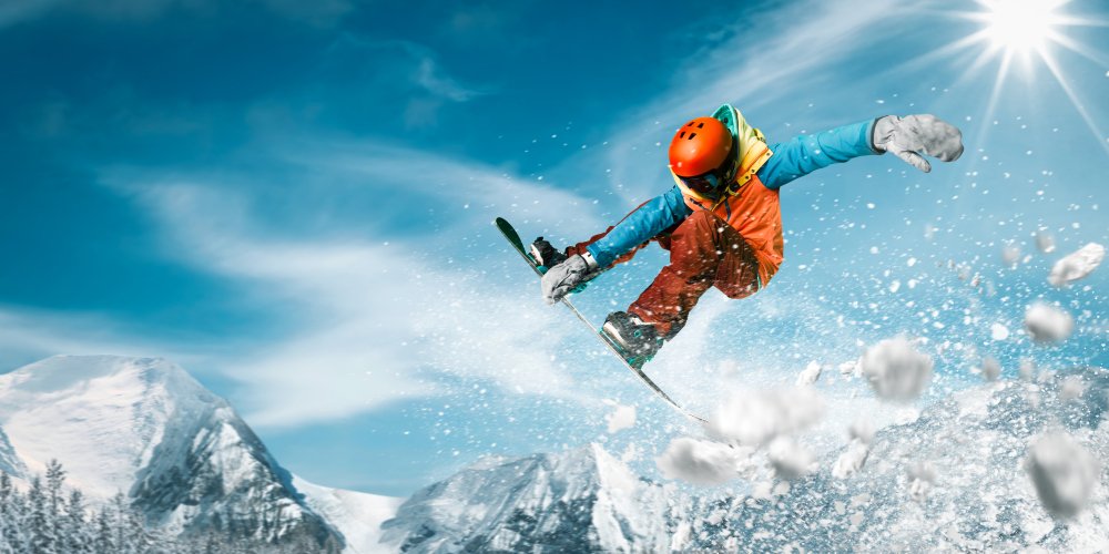 A snowboarder doing an extreme jump through the air.