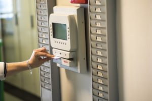 A woman clocking-in to work.