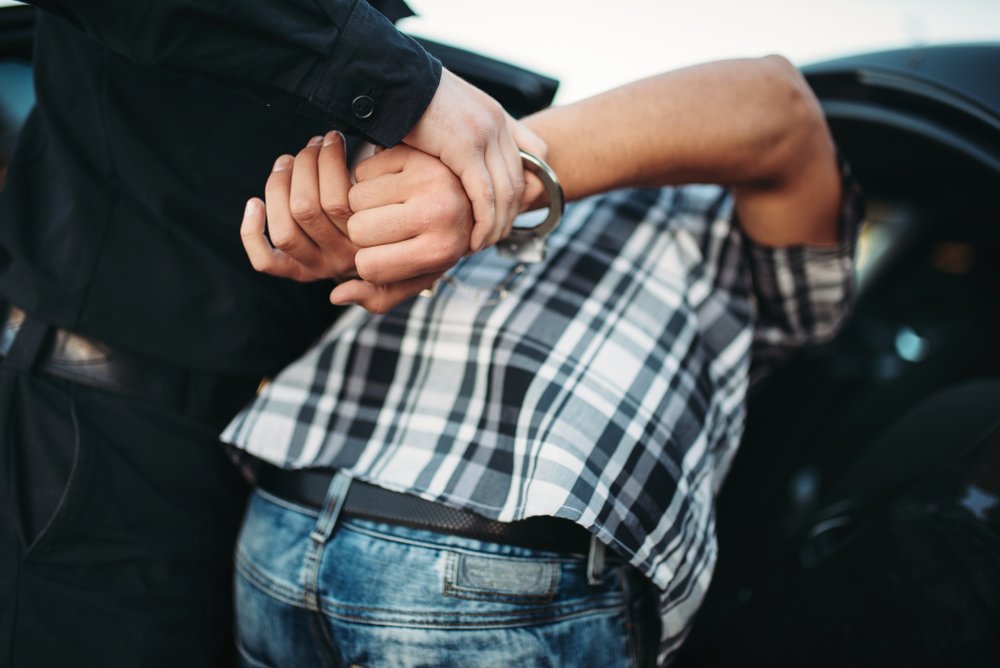A man getting arrested for a misdemeanor while out on bail.