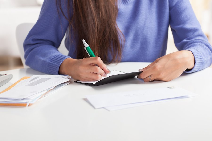 Woman writing check to bankruptcy trustee