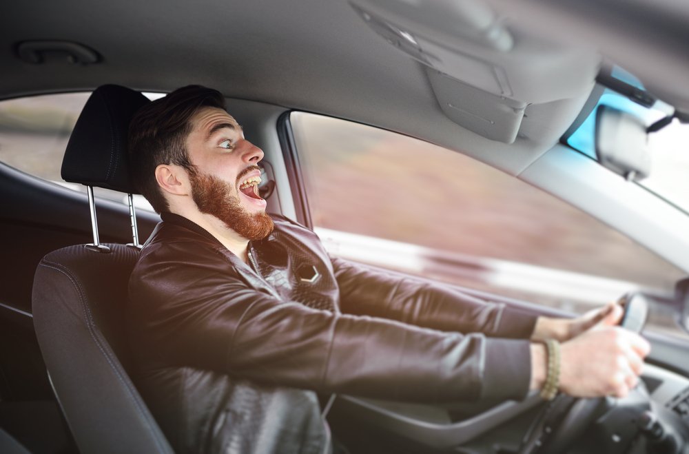 A man exhibiting extreme jubilation on a joyride.