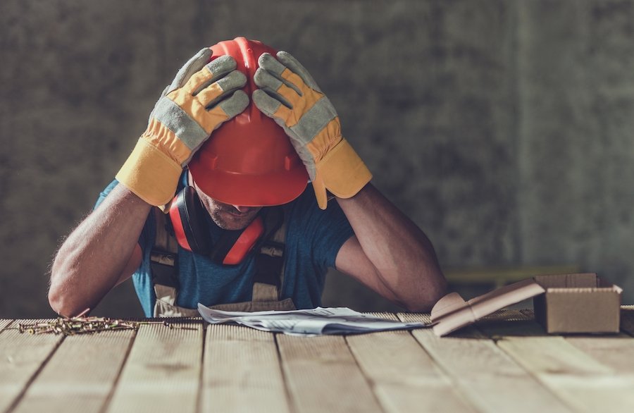 Construction worker sad after being misclassified as an independent contractor