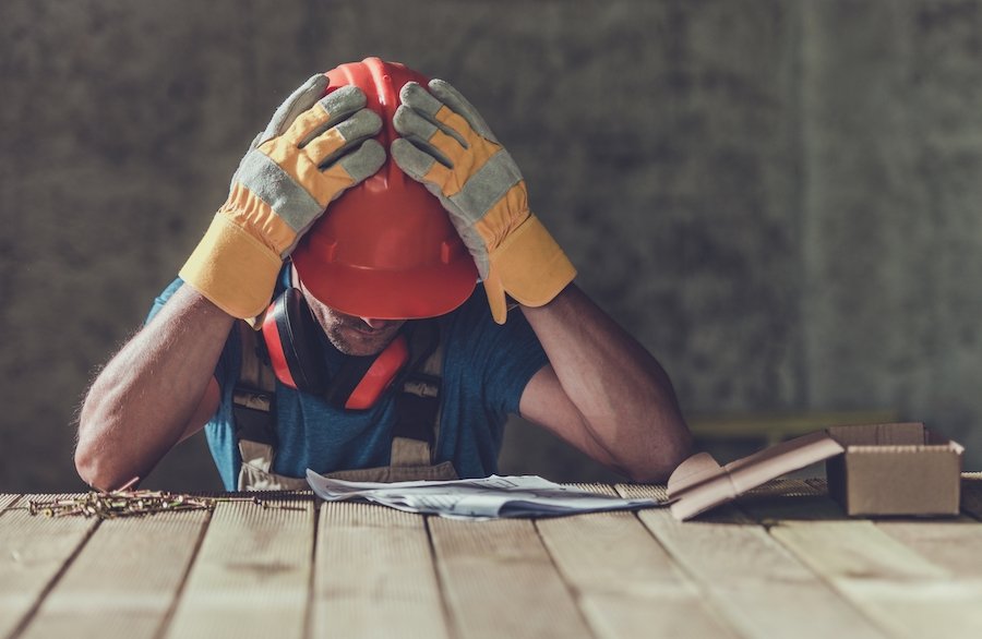 Construction worker sad after being convicted of a crime