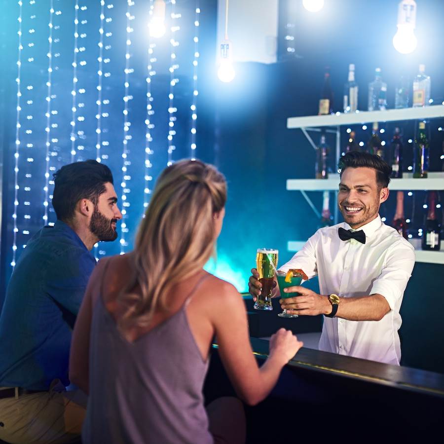 Bartender serving drinks to customers