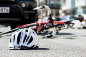 bike and helmet on street in aftermath of crash