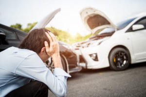 Man looking distraught in aftermath of fender bender