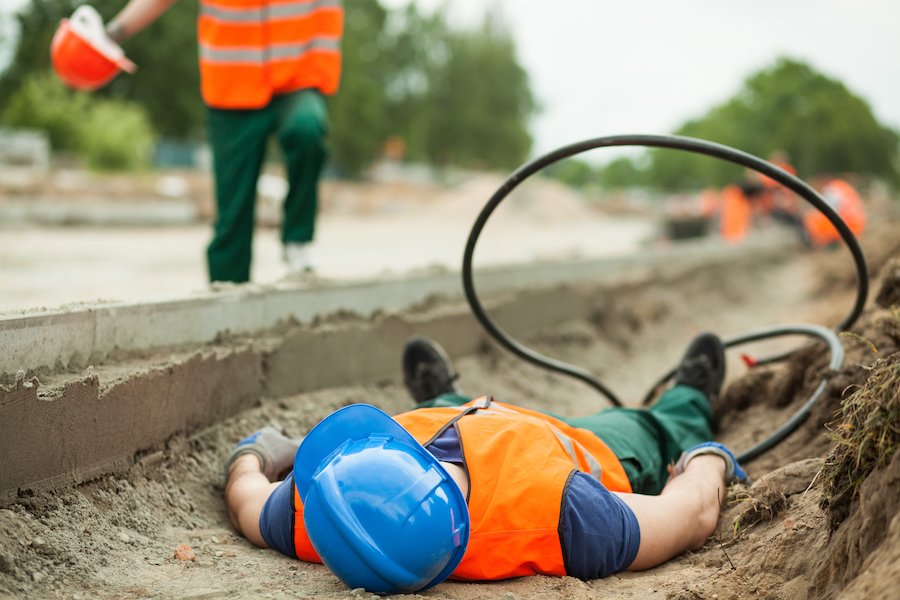 Constructing worker lying down in ditch after being electrocuted