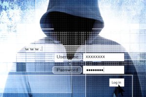 Hooded person entering a stolen password