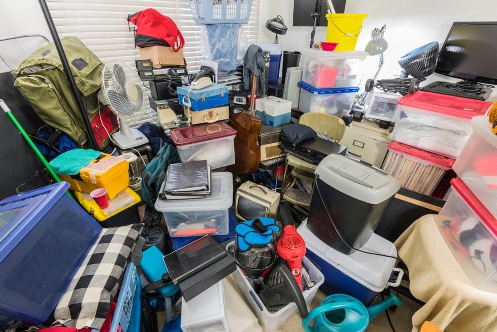 A hoarders room filled with stuff.