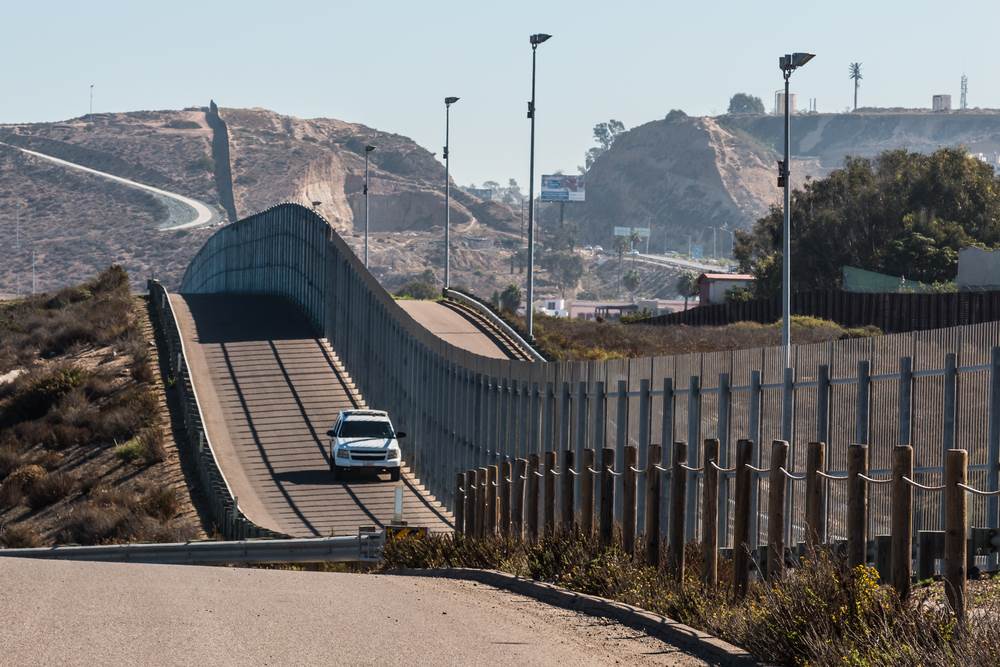 An immigration police vehicle driving by the US border.