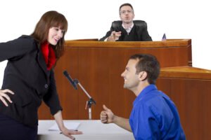 defendant giving thumbs up to his lawyer in the courtroom