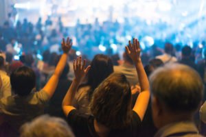 Evangelical church with congregants raising their arms
