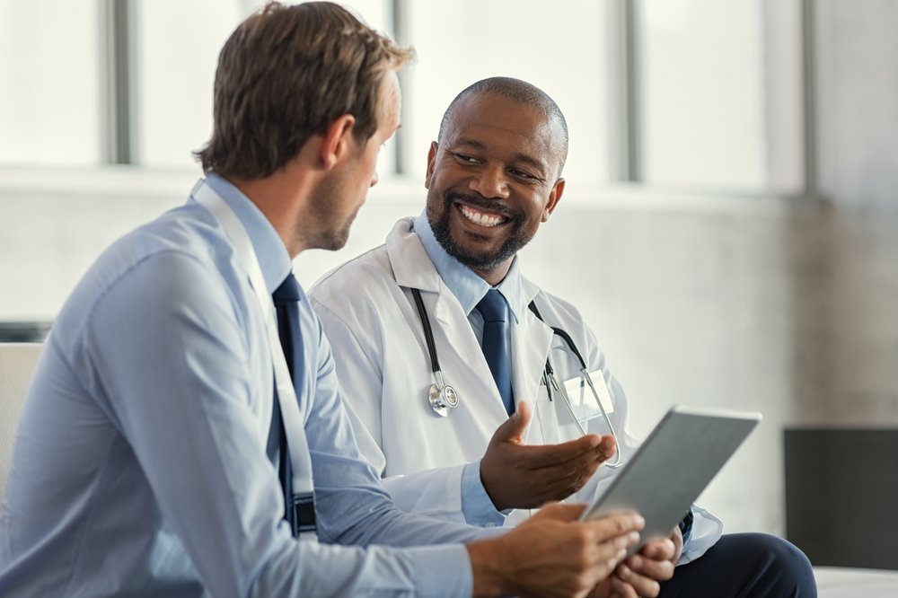 A slip and fall doctor discussing medical liens with his patient.