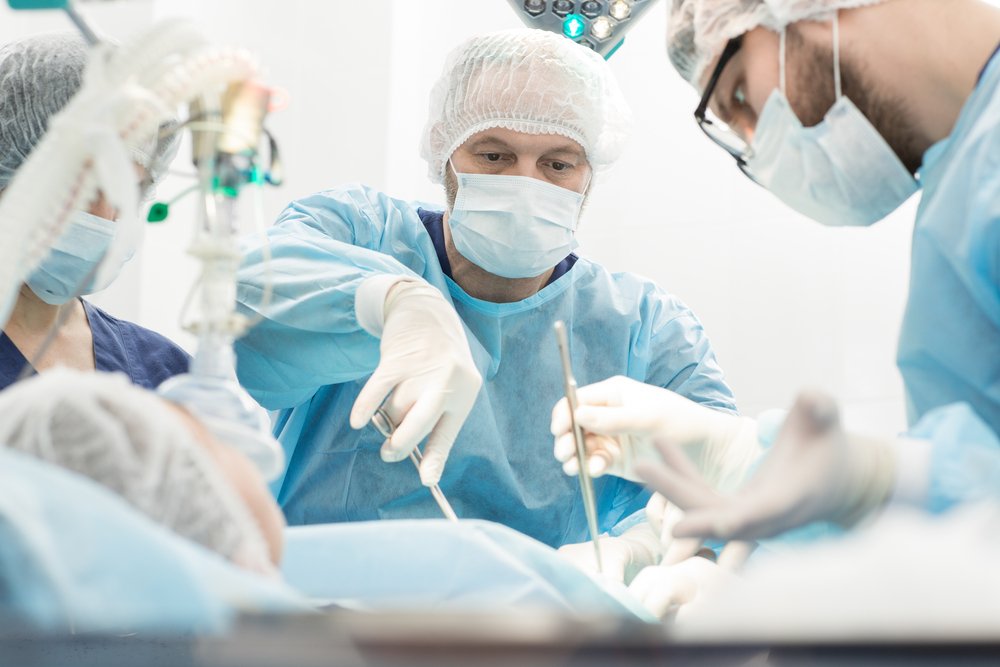 A surgeon in the middle of a surgery, potentially on a work related injury.