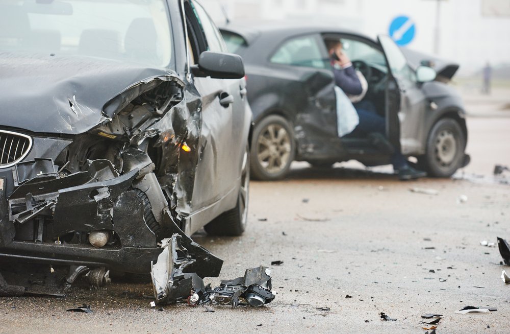 A car crash scene with both cars badly damaged.