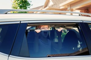 A child left unattended in the backseat of a car.