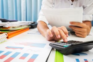 Financial analyst using a calculator