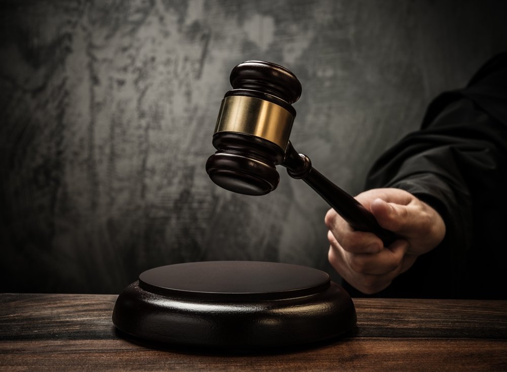 A judge striking his gavel after sentencing someone for attempted murder.