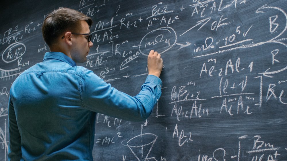 A mathematician working on a difficult math formula, possibly the auto accident settlement formula.