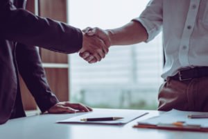 A client shaking hands with his newly chosen personal injury attorney.