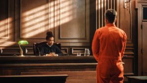 Probationer in orange jumpsuit before judge