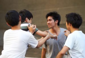 Young men pushing and shoving each other.