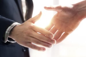 A handshake representing coming to a settlement agreement.