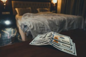 Cama de hotel con dinero en el mostrador