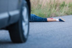 Victim lying on the road following a car crash