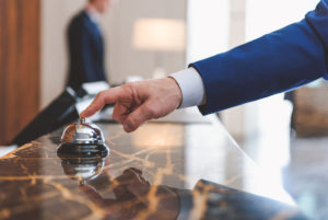 Man ringing bell at concierge desk