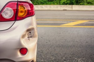 A car's bumper dented after a minor hit and run accident.