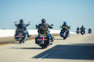 Back view of six motorcyclists on highway