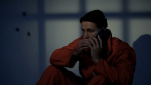 Prisoner talking on secret cell phone