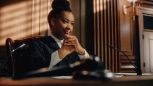 A judge sitting by her gavel on the bench satisfied with the progress in a person's probation possibly leading to a probation termination.