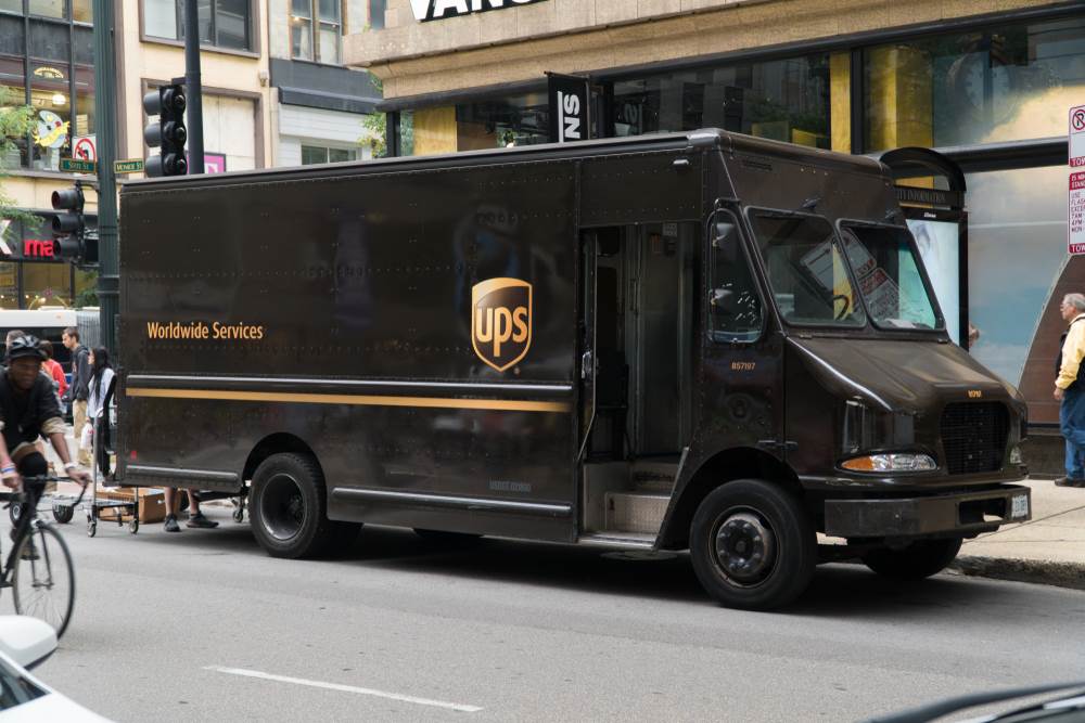 A UPS truck on a busy city street.