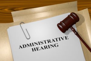 Paper that says "Administrative Hearing" with a gavel