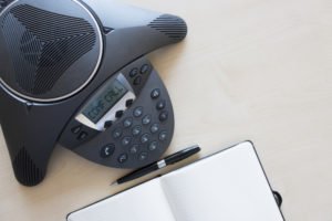 Phone that says "conference call" on desk