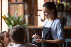 A server at a California restaurant, providing good service in hope of receiving a nice tip.