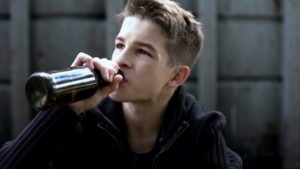 Un chico bebiendo alcohol que le fue dado por un adulto en violación de NRS 201.110.
