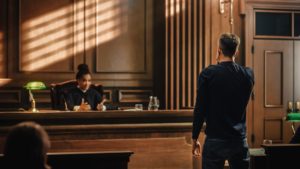 Interior courtroom shot: A parolee speaking with a judge during his unsupervised probation period.