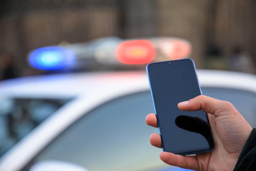 Police officer searching someone's smartphone.