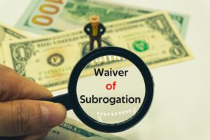 Cash with a sign that says "waiver of subrogation"