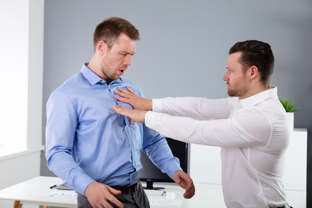 A man pushing another during a heated argument, which could result in an assault or battery charge depending on the jurisdiction.